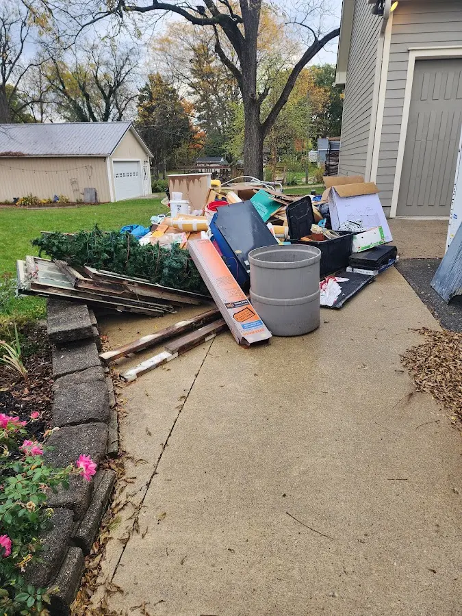 Dumpster being loaded with debris for Residential Dumpster Rental in Gladwin